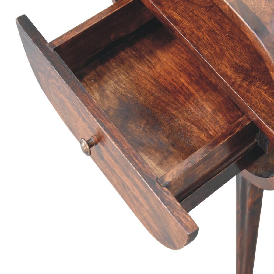 Open wooden nightstand drawer, close-up view.