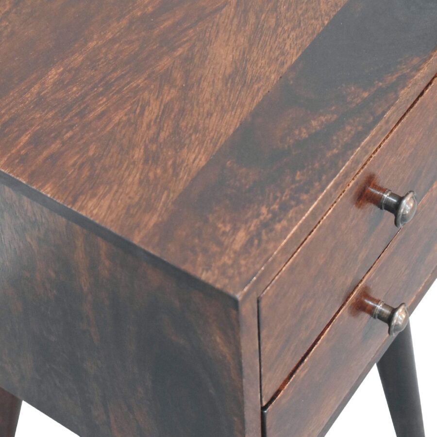 Wooden nightstand with metal handles detail.