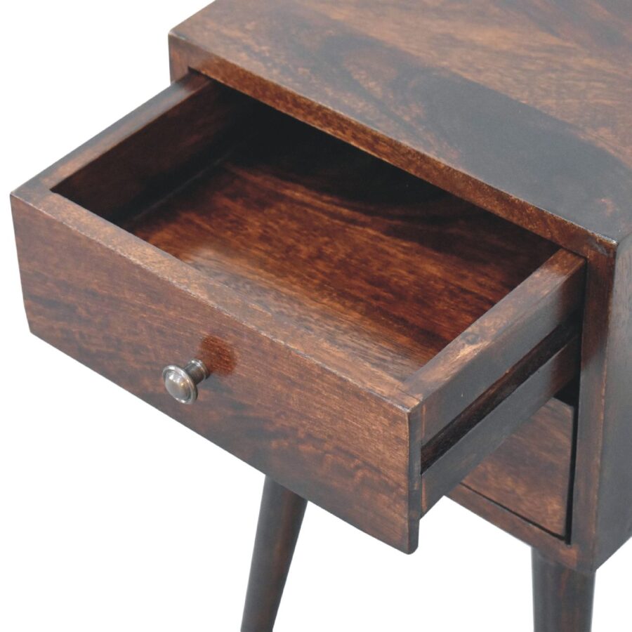 Wooden bedside table with open drawer.