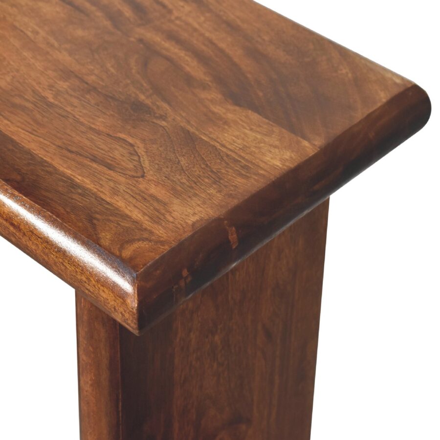 Close-up of polished wooden table corner.