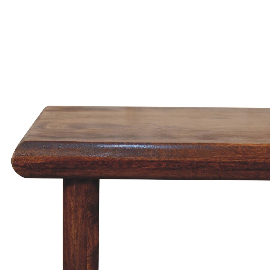 Close-up of wooden table corner on white background.