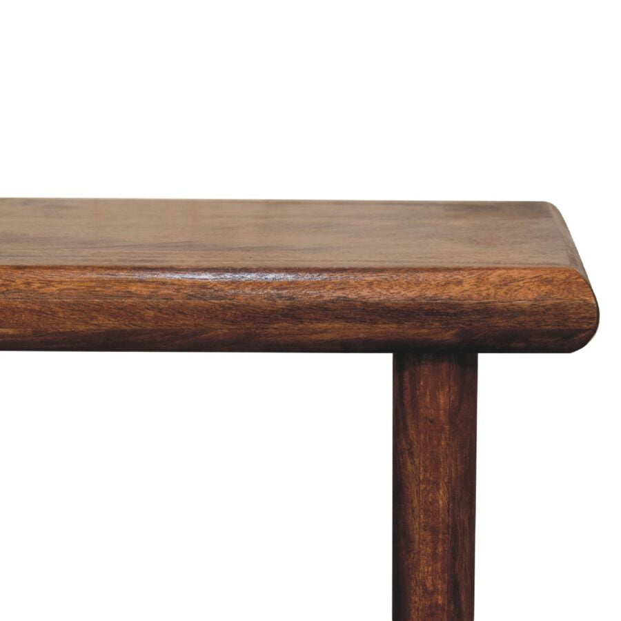 Corner of brown wooden table against white background.