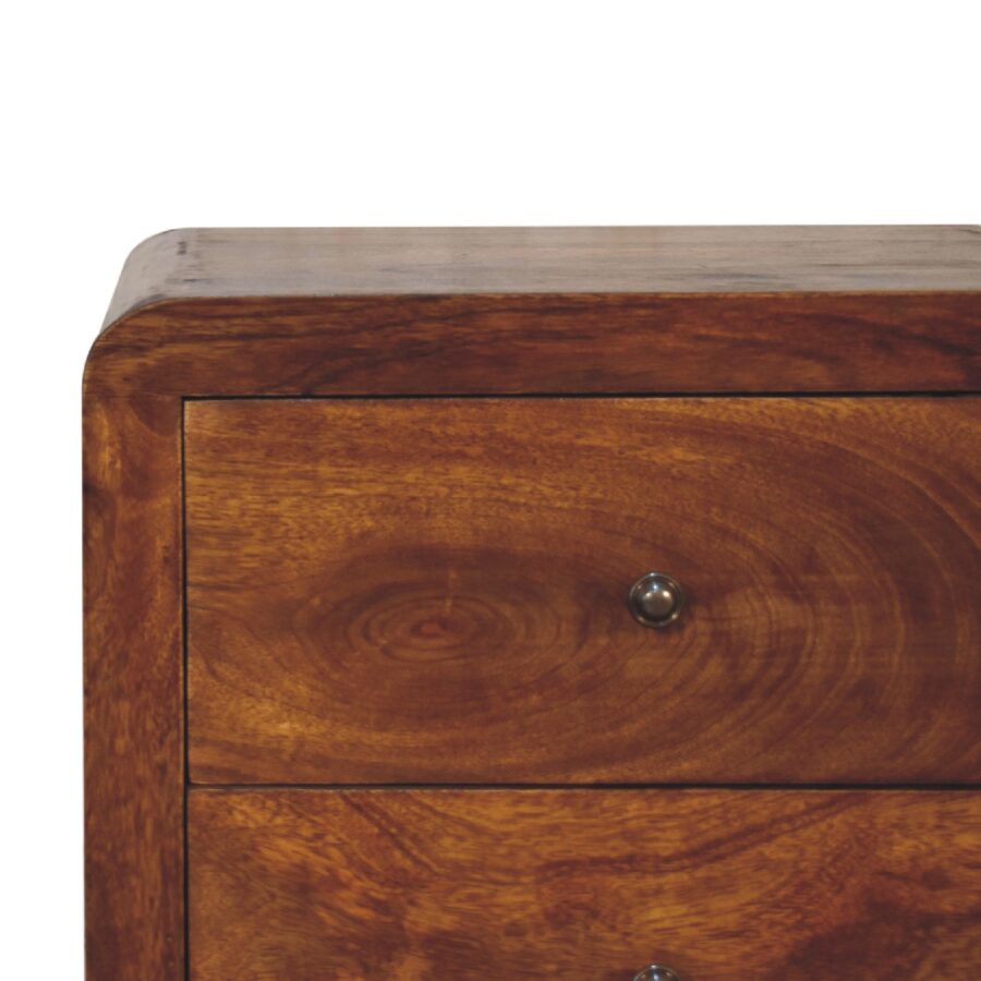 Wooden bedside drawer with metal handle.