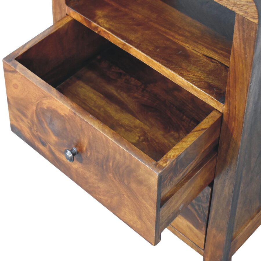 Open wooden bedside drawer with metal knob.