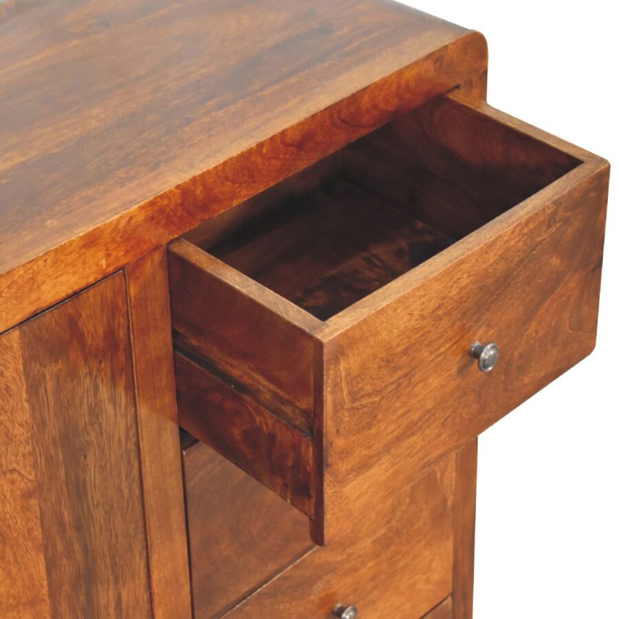 Open wooden desk drawer, close-up view.