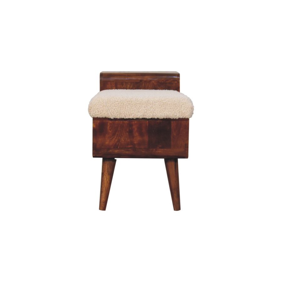 Wooden stool with sheepskin seat pad.